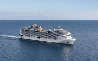 MSC Meraviglia sailing on a calm sea, with mountains on the horizon