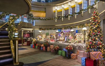 Gingerbread village and Christmas tree in the atrium of a Holland America Line ship