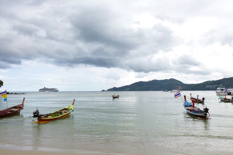 Phuket: Long-tail boats on Patong Beach, with a cruise ship at anchor