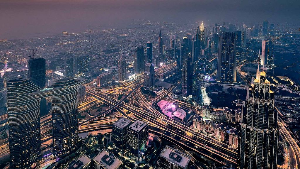 Dubai at night, with its skyscrapers lit up
