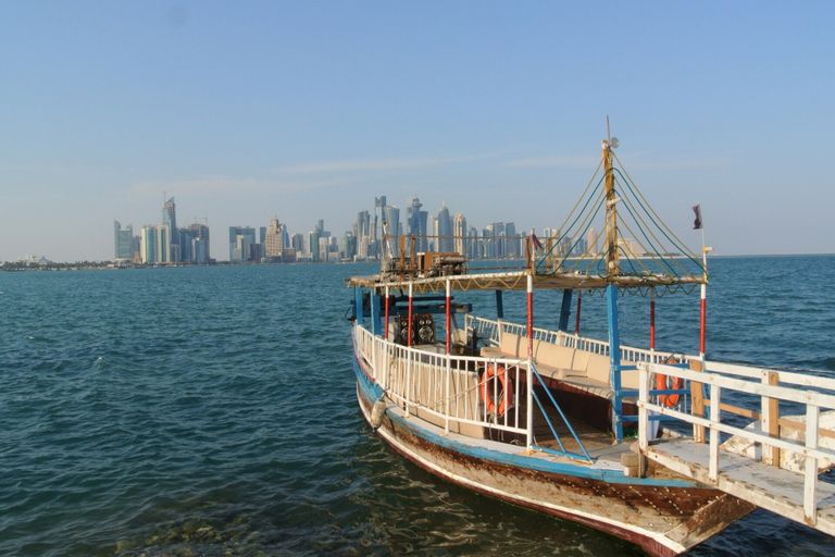 Doha: A dhow on the Corniche, with the West Bay towers behind